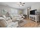 Cozy living room featuring shuttered windows, comfortable seating, area rug, and decorative nautical accessories at 634 Cypress Ln., North Myrtle Beach, SC 29582