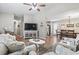 Spacious living room with comfortable seating, television, area rug, and open layout to kitchen/dining at 634 Cypress Ln., North Myrtle Beach, SC 29582