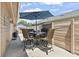 Outdoor patio features seating under a large umbrella and privacy fencing at 634 Cypress Ln., North Myrtle Beach, SC 29582