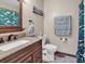 Well-maintained bathroom featuring granite countertop and complementing blue towels at 6628 Mallard View Point, Myrtle Beach, SC 29588