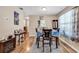 Dining room with hardwood floors, table with seating for six, and adjacent living area at 6628 Mallard View Point, Myrtle Beach, SC 29588