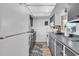 Galley kitchen featuring stainless appliances, wood floors, and a stylish area rug at 6628 Mallard View Point, Myrtle Beach, SC 29588