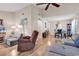 Comfortable living room featuring a recliner, hardwood floors, and abundant natural light at 6628 Mallard View Point, Myrtle Beach, SC 29588