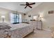Bright bedroom with ceiling fan, window, and dresser with decorative lamps at 6628 Mallard View Point, Myrtle Beach, SC 29588