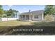 Expansive backyard with a screened-in porch and well-maintained lawn, perfect for outdoor enjoyment at 68 Voyagers Dr., Pawleys Island, SC 29585