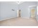 Carpeted bedroom with ceiling fan, a doorway, and large windows at 68 Voyagers Dr., Pawleys Island, SC 29585