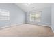 Bright bedroom features neutral carpet, a ceiling fan, and plenty of natural light at 68 Voyagers Dr., Pawleys Island, SC 29585