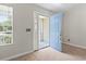 Home entryway featuring a blue front door with decorative glass and beige carpet at 68 Voyagers Dr., Pawleys Island, SC 29585