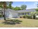 Charming single-story home featuring an attached garage, a cozy front porch and lush landscaping at 68 Voyagers Dr., Pawleys Island, SC 29585