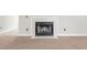 Close-up of a classic white-tiled fireplace with a black metal grate in a cozy living room at 68 Voyagers Dr., Pawleys Island, SC 29585