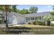 Charming single-story home featuring a front porch, manicured landscaping, and an attached garage at 68 Voyagers Dr., Pawleys Island, SC 29585