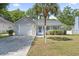 Charming single-story home with a garage, landscaped yard, and lovely palm tree in a sunny neighborhood at 68 Voyagers Dr., Pawleys Island, SC 29585