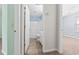 Hallway view of bathroom and bedroom featuring light-colored walls and carpet at 68 Voyagers Dr., Pawleys Island, SC 29585