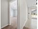 Hallway with view to carpeted bedroom with ceiling fan and tile flooring at 68 Voyagers Dr., Pawleys Island, SC 29585