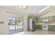 Eat-in kitchen with stainless steel refrigerator, white appliances and sliding glass door at 68 Voyagers Dr., Pawleys Island, SC 29585