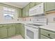 Kitchen with green cabinets, white countertops, and modern appliances at 68 Voyagers Dr., Pawleys Island, SC 29585