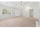 Cozy living room with neutral carpet, large window, and fireplace, offering a comfortable atmosphere at 68 Voyagers Dr., Pawleys Island, SC 29585