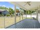 Screened porch with gray wood floors, a ceiling fan, and views of the fenced-in backyard at 68 Voyagers Dr., Pawleys Island, SC 29585