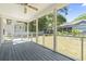 Relax on this screened porch with wood floors and a fan; enjoy the views of the backyard at 68 Voyagers Dr., Pawleys Island, SC 29585