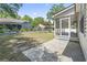 Relaxing screened porch with a concrete patio, overlooking a spacious yard with fencing and landscaping at 68 Voyagers Dr., Pawleys Island, SC 29585