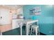 Bright kitchenette featuring white cabinetry, a dining table, and essential appliances at 6803 N Ocean Blvd. # 328, Myrtle Beach, SC 29572