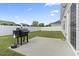 Spacious backyard features a black grill on a concrete slab and white fence, great for entertaining at 712 Hobonny Loop, Longs, SC 29568