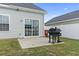 Fenced backyard with a concrete slab, black grill and sliding glass door at 712 Hobonny Loop, Longs, SC 29568