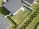 Aerial view of a spacious backyard with a white fence, patio, and manicured lawn, perfect for outdoor activities at 712 Hobonny Loop, Longs, SC 29568