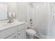 Bathroom featuring a single sink vanity, a large mirror, and a shower with a patterned shower curtain at 712 Hobonny Loop, Longs, SC 29568