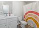 Bathroom featuring a single sink vanity, a toilet, a rainbow shower curtain, and hardwood floors at 712 Hobonny Loop, Longs, SC 29568