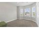 Bright bedroom with neutral carpet, ample natural light from large bay windows, and a ceiling fan at 712 Hobonny Loop, Longs, SC 29568