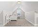Charming bedroom featuring a white bed frame, complemented by light gray walls and plush carpeting at 712 Hobonny Loop, Longs, SC 29568