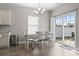 Bright dining area features a sliding glass door leading to the backyard and a modern light fixture at 712 Hobonny Loop, Longs, SC 29568
