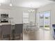 Dining area adjacent to kitchen features natural light and modern chandelier at 712 Hobonny Loop, Longs, SC 29568