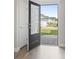 Open entryway featuring a stylish front door and wood flooring, leading into a bright and airy home at 712 Hobonny Loop, Longs, SC 29568