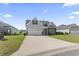 Charming two-story home with stone accents, driveway, and manicured front lawn at 712 Hobonny Loop, Longs, SC 29568