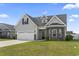 Charming home with attached garage, welcoming front porch, and manicured lawn at 712 Hobonny Loop, Longs, SC 29568