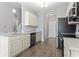 Well-lit kitchen featuring stainless steel appliances, white cabinets, and marble countertops at 712 Hobonny Loop, Longs, SC 29568