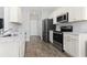 Bright kitchen with white cabinets, marble counters, and modern stainless steel appliances at 712 Hobonny Loop, Longs, SC 29568