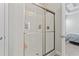 Shower featuring sleek glass doors, modern fixtures, and shelving for storing bath products at 712 Hobonny Loop, Longs, SC 29568