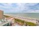 Aerial view of the beach, pool, and ocean with plenty of beachgoers enjoying the sun at 7200 N Ocean Blvd. # 1058, Myrtle Beach, SC 29572