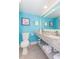 Bright bathroom with stylish granite countertop, modern vanity, and decorative coral artwork on blue walls at 7200 N Ocean Blvd. # 1058, Myrtle Beach, SC 29572