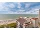 Scenic view of the beach and ocean from an upper-level condo featuring white sand and beautiful blue water at 7200 N Ocean Blvd. # 1058, Myrtle Beach, SC 29572