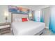 Serene bedroom featuring a king-sized bed, calming artwork, and ocean view curtains at 7200 N Ocean Blvd. # 1058, Myrtle Beach, SC 29572