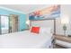 Comfortable bedroom with closet space, a king-sized bed, and calming artwork at 7200 N Ocean Blvd. # 1058, Myrtle Beach, SC 29572