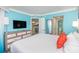 Spacious bedroom with ensuite bathroom, a king-sized bed, and a modern dresser at 7200 N Ocean Blvd. # 1058, Myrtle Beach, SC 29572