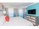 Bright bedroom with a king-sized bed, modern dresser, and ocean view curtains at 7200 N Ocean Blvd. # 1058, Myrtle Beach, SC 29572