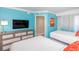 Inviting bedroom with two beds, a TV, and colorful accent wall at 7200 N Ocean Blvd. # 1058, Myrtle Beach, SC 29572