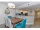 Contemporary dining room with stylish light fixture and a view into the modern kitchen at 7200 N Ocean Blvd. # 1058, Myrtle Beach, SC 29572