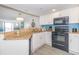 Modern kitchen featuring stainless steel appliances, granite countertops, and sleek white cabinetry at 7200 N Ocean Blvd. # 1058, Myrtle Beach, SC 29572